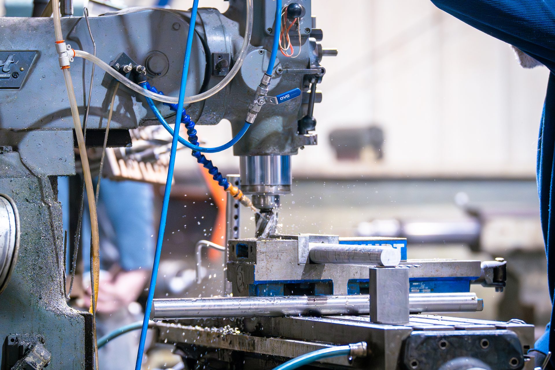 CNC milling machine in action with coolant spray