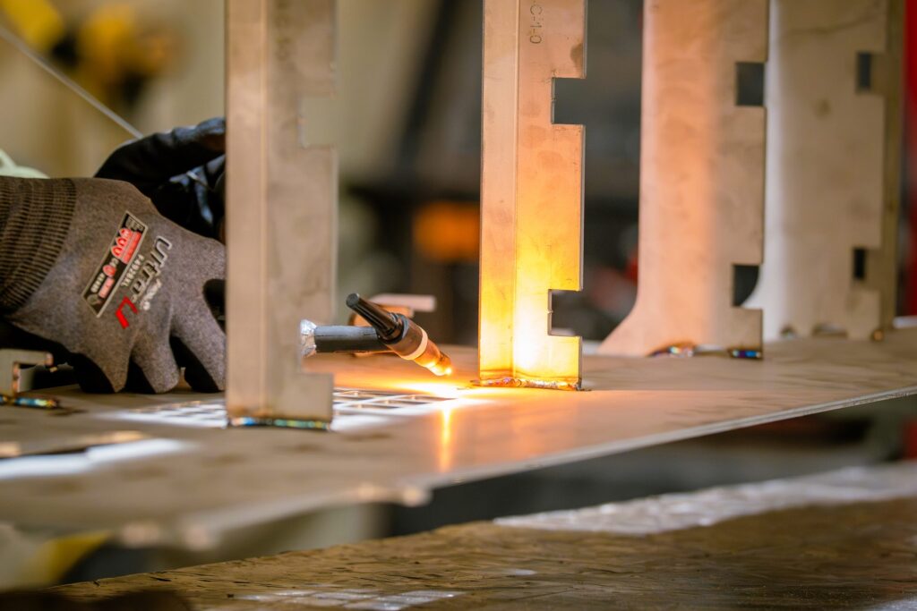 Close-up of TIG welding with orange glow on stainless steel fabrication